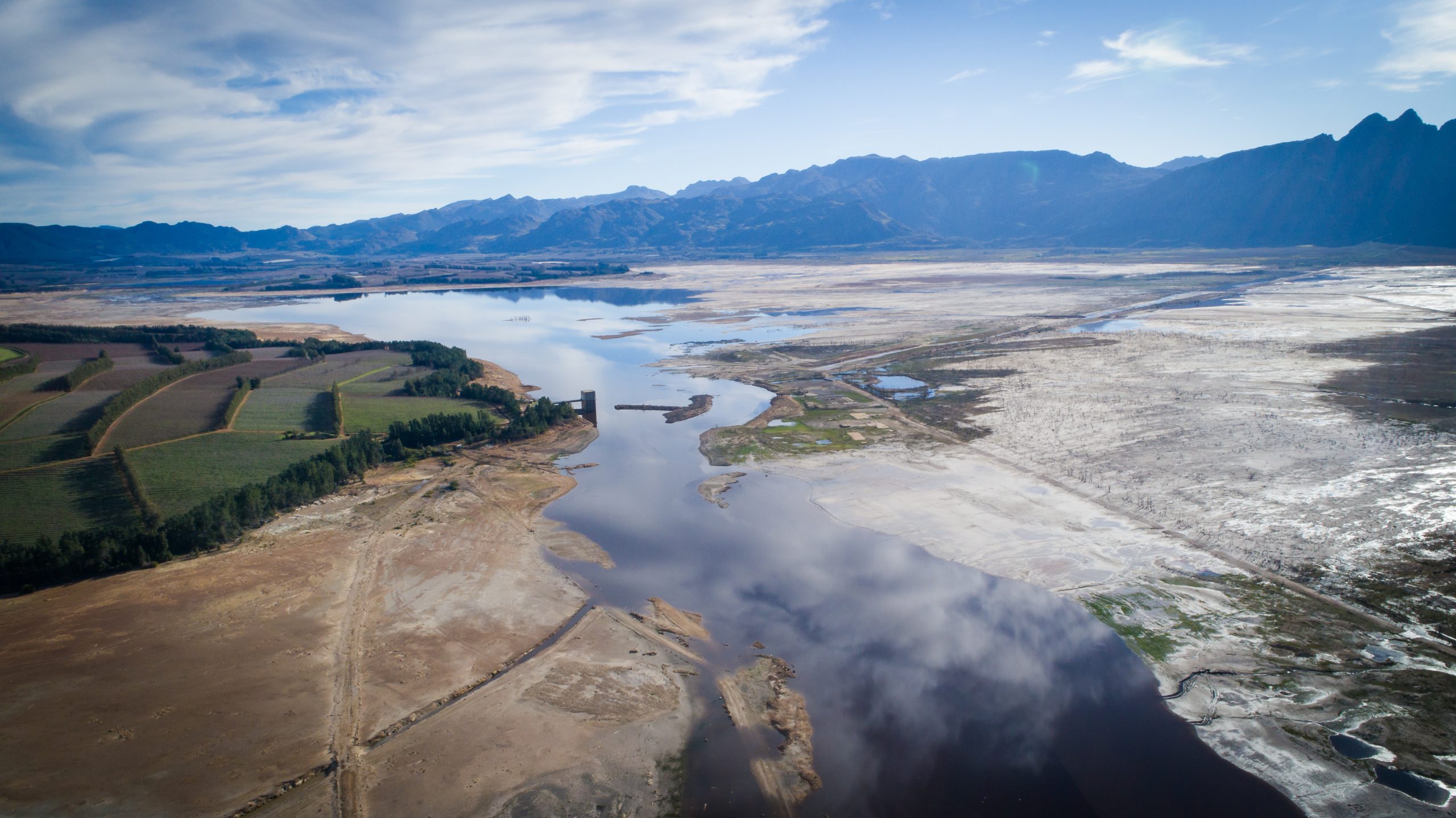 Aerial image over a very dry Theewaterskloof dam during the worst drought in decades in the Western Cape of South Africa with massive patches of barren earth exposed